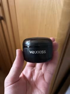 Customer photo 3 of the WAXKISS Mini Wax Warmer held in a hand